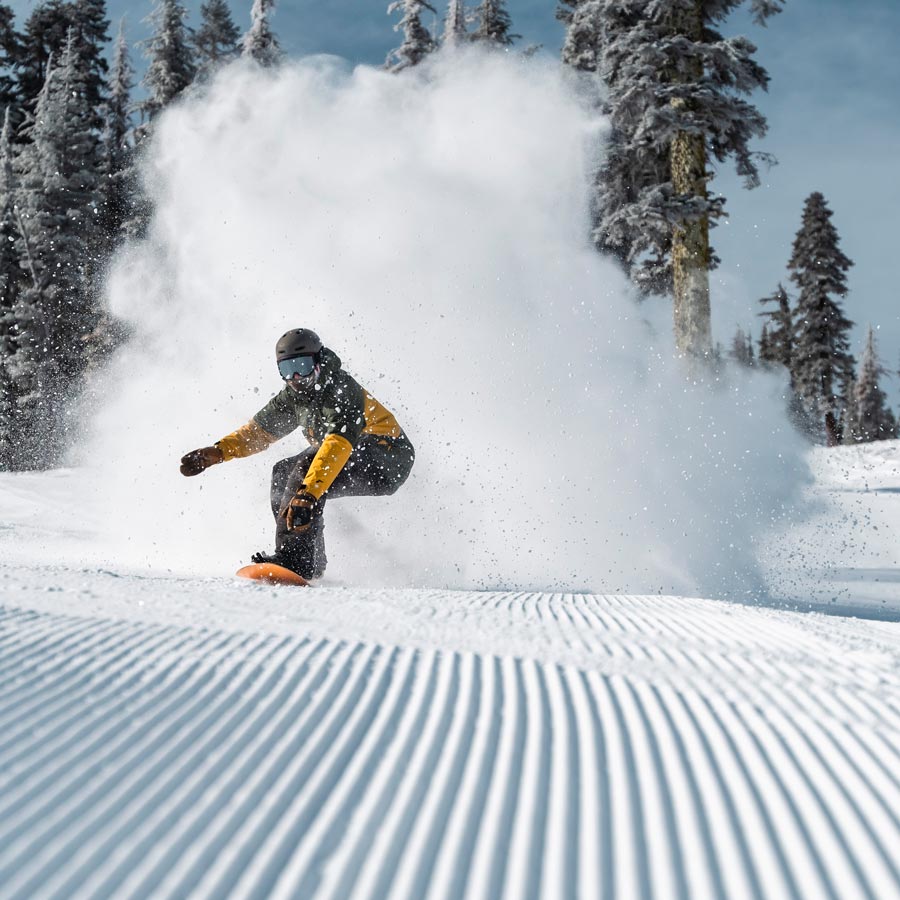 Snowboarder on a groomer at Sugar Bowl Resort. Near Truckee California, north of Lake Tahoe.